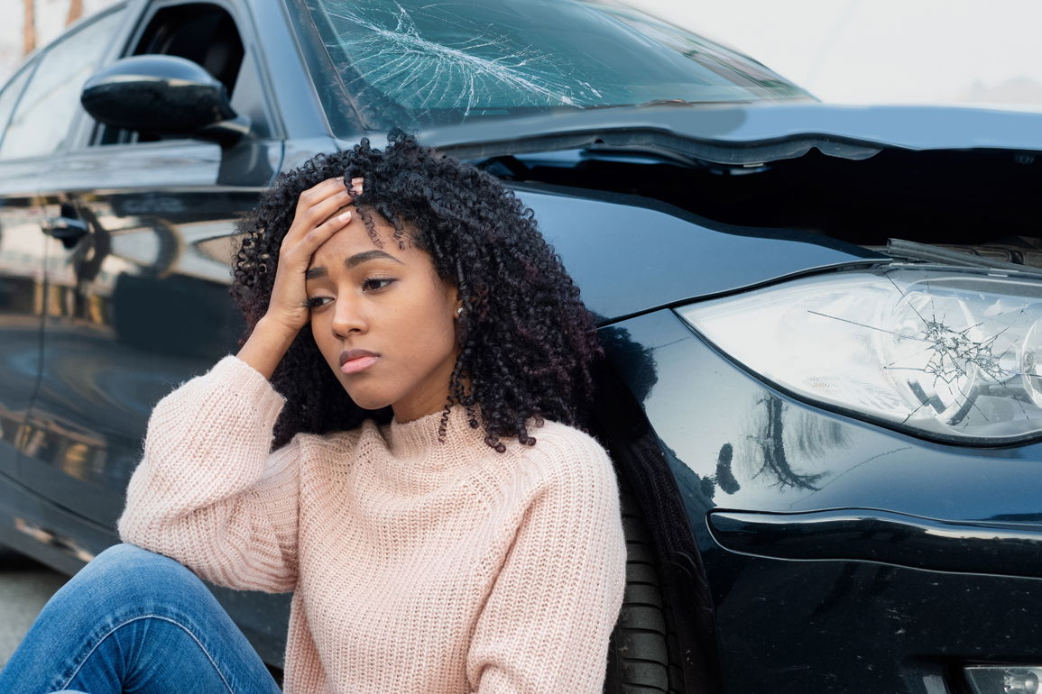 Car Accident Victim Sitting By Car