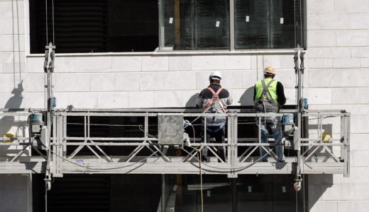 Construction workers on a lift