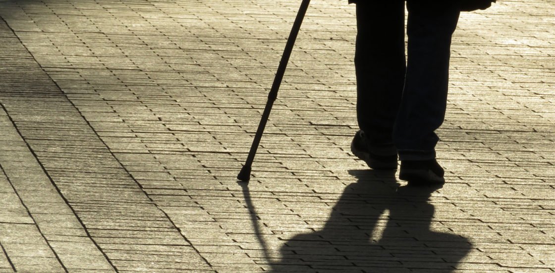 Man with cane requesting reasonable accommodation